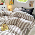 Close-up of cotton comforter showcasing minimalist stripe design