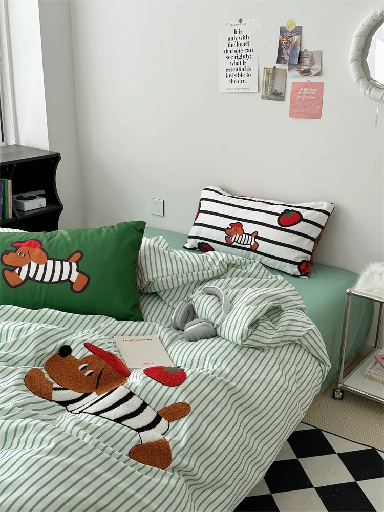 Children's bedroom with green bedspread featuring cartoon dog design, striped pillow, and checkered floor.