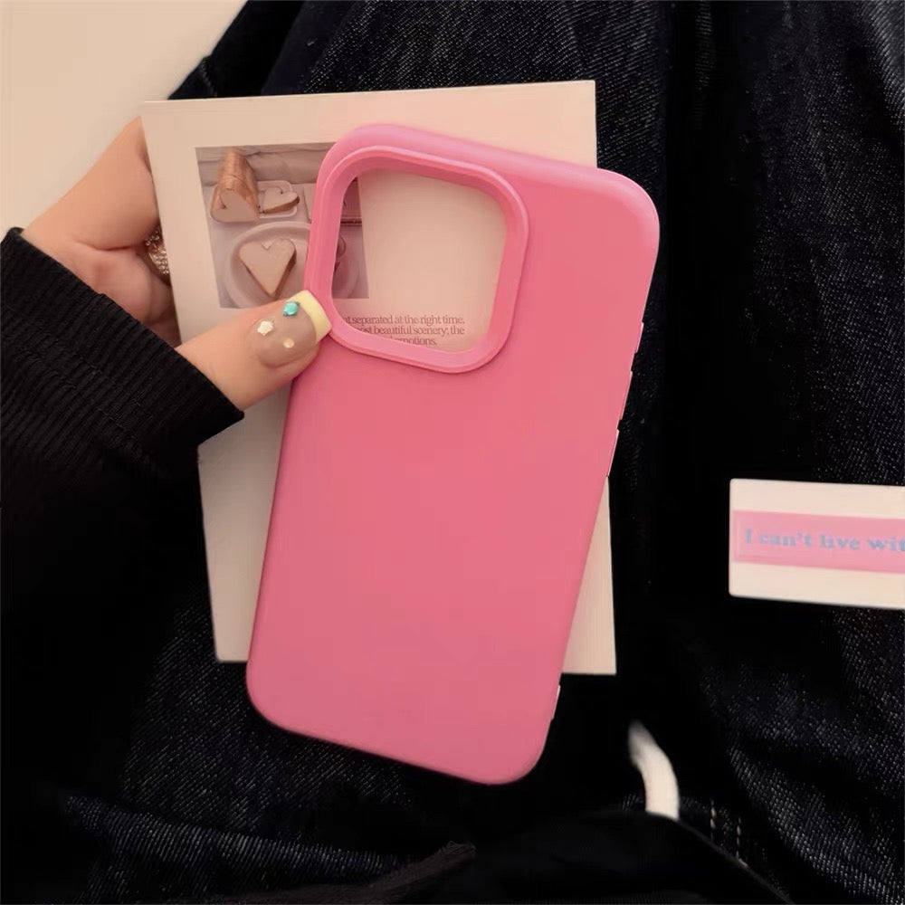 Pink phone case held by a person with a blurred background