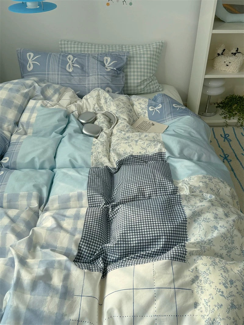 Bed with blue and white checkered bedding in a room setting.