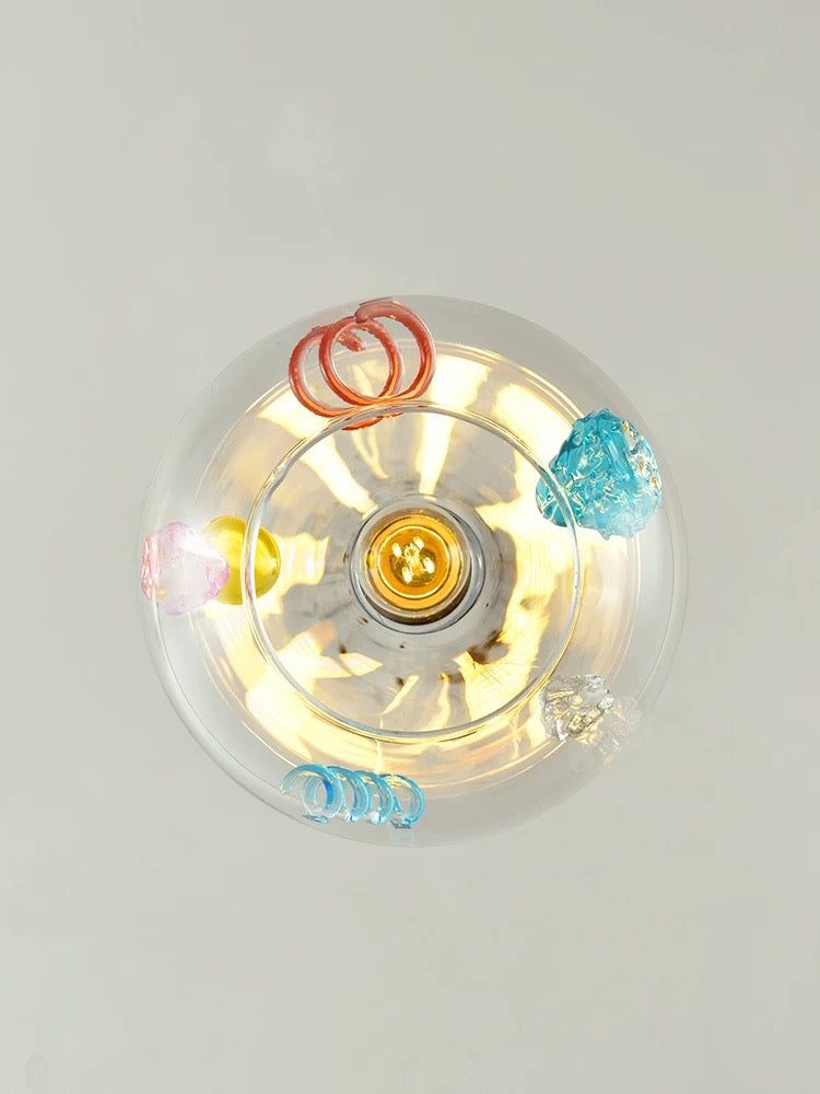 Clear plastic container with colorful paper clips on a light gray background