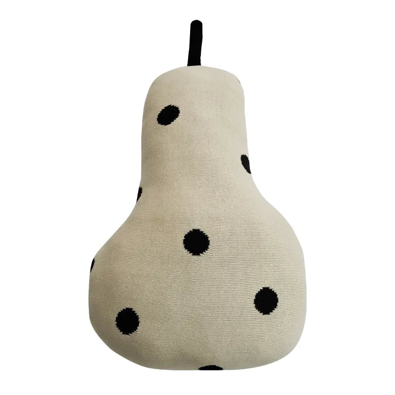 A plush pear-shaped cushion in a textured cream fabric with black polka dots and a black stem, shown against a plain white background.