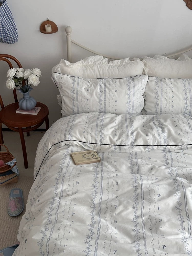 Bed with white bedding in a bedroom setting