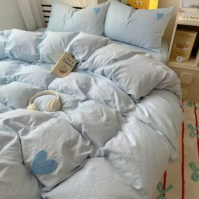 Pastel blue bedding set with embroidered heart pillows in a soft girl aesthetic room