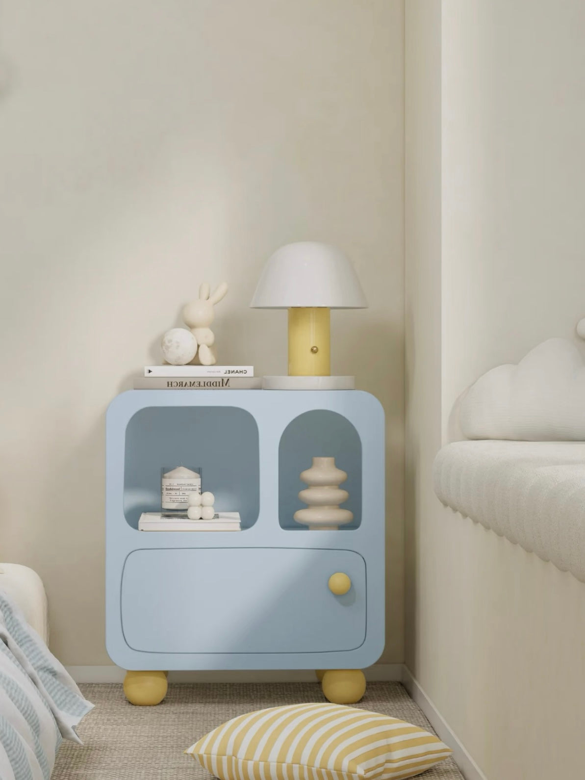 A blue nightstand viewed from the front shows yellow ball feet and two display cubbies above its drawer.