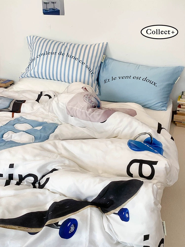 Blue rabbit bedding set with graphic lettering and striped details