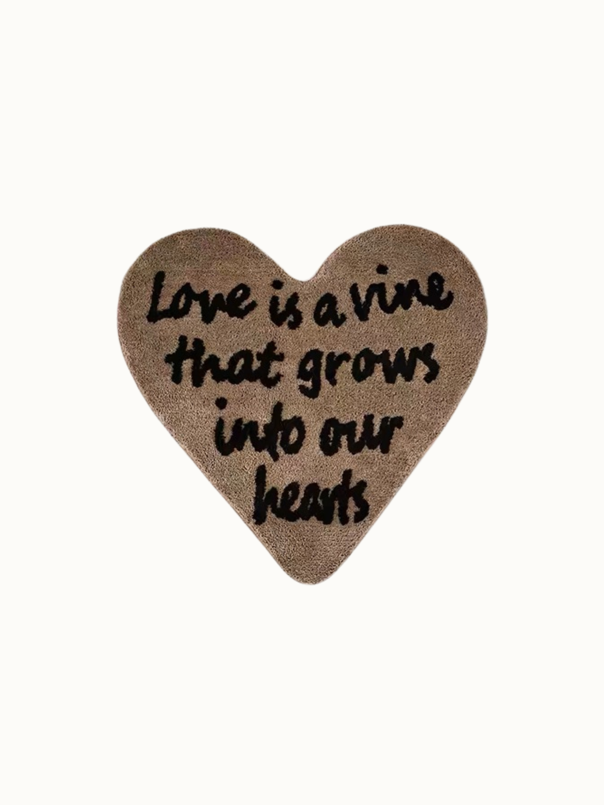 Brown heart rug shown against a plain background, with black love lettering spread across the pile surface.