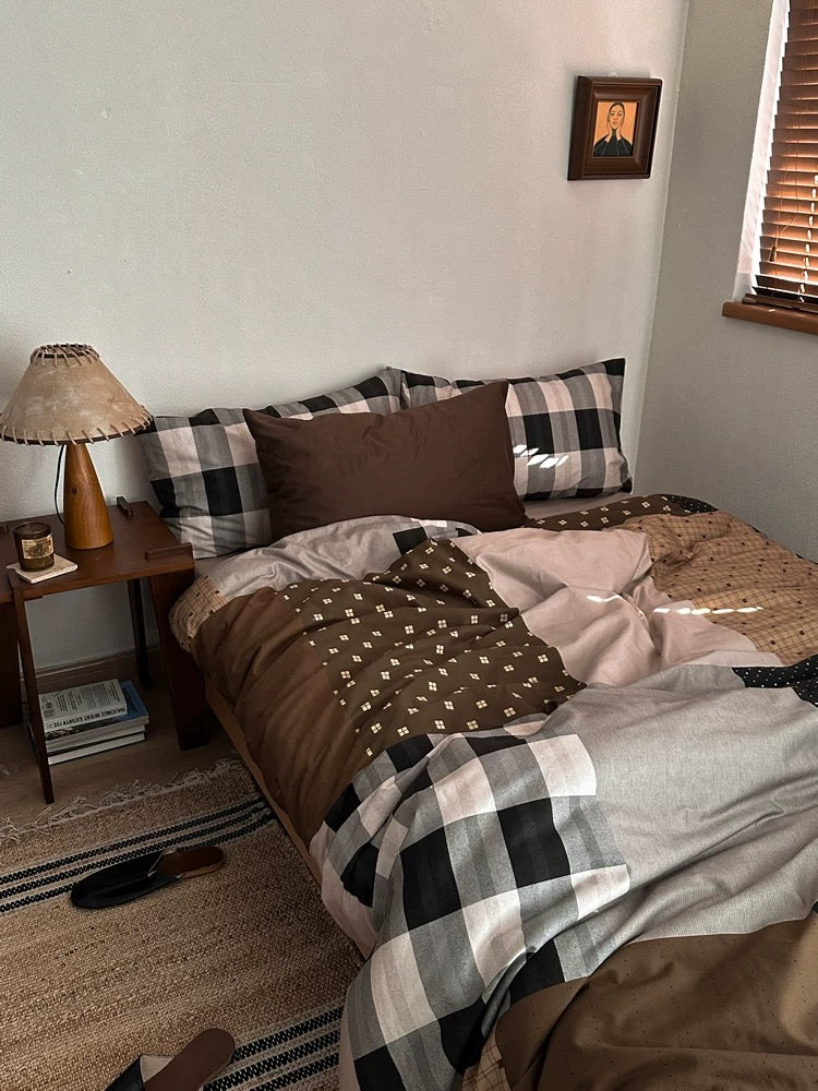 Brown gingham bedding with layered pillows in a cozy preppy bedroom