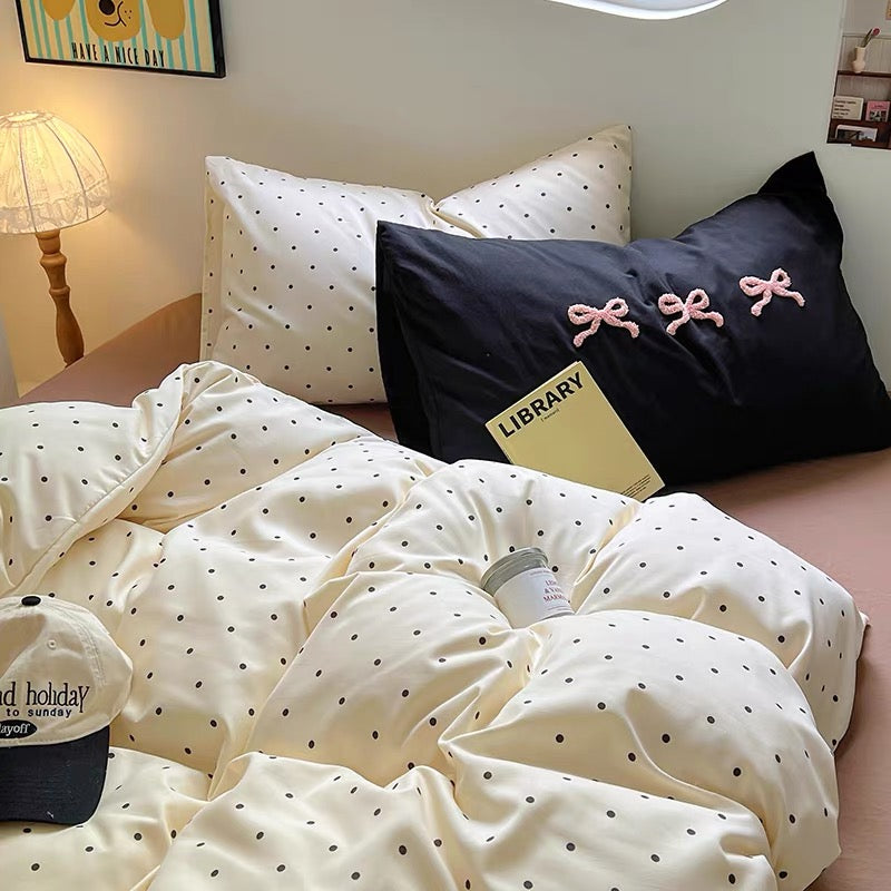 A cozy brown polka dot bedding set styled in a soft girl dorm room with a stuffed puppy and headphones