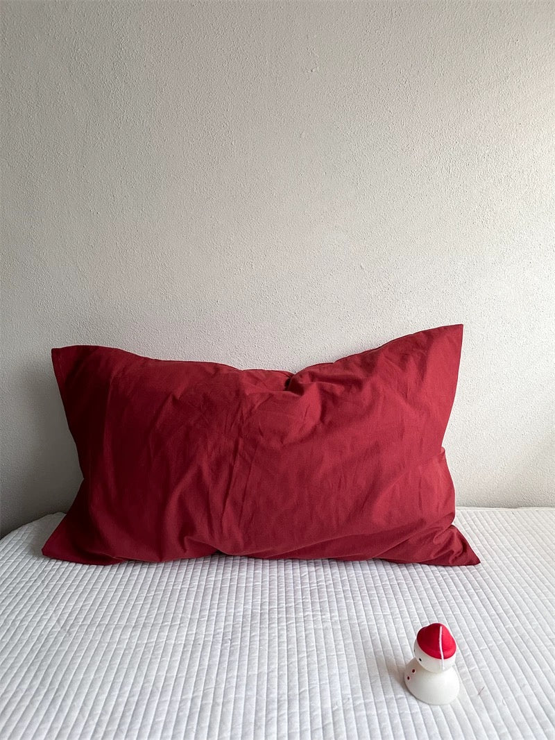 A burgundy red pillowcase is shown on its own with a plain rectangular outline.