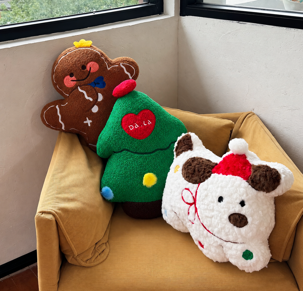 Gingerbread, Christmas tree and puppy decorative pillows arranged on a mustard armchair