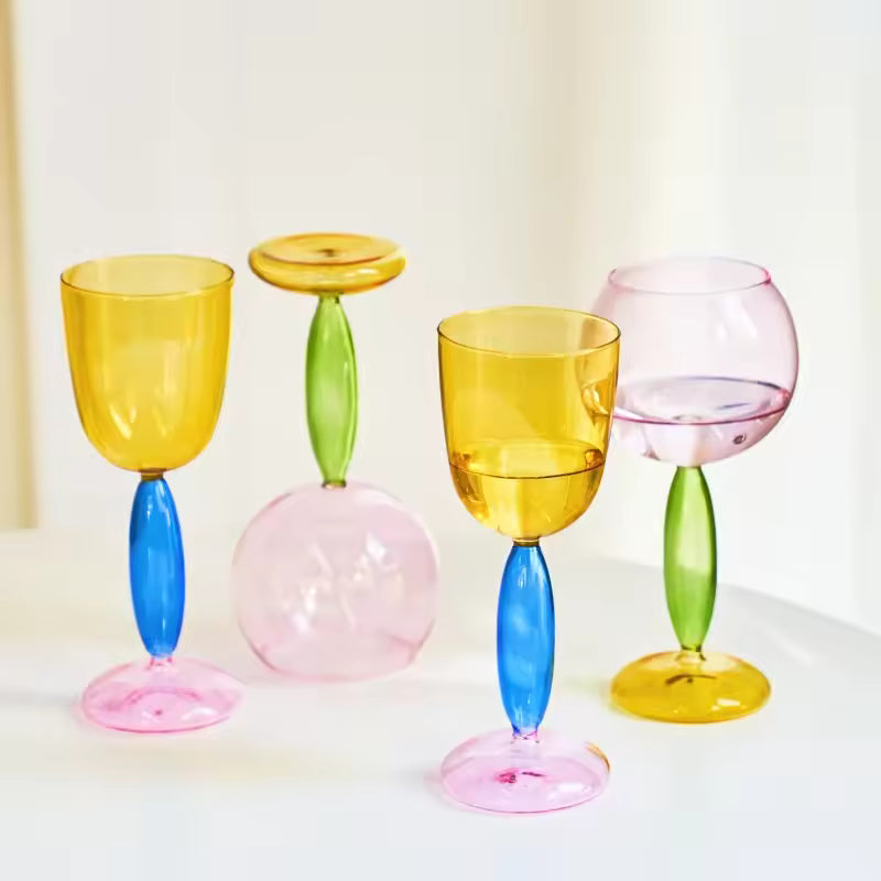 Set of colorful glass goblets on a white background