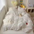 Close-up of soft cotton pillowcases featuring delicate heart patterns.