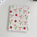 White case with strawberry, tulip, and bow pattern on a white background