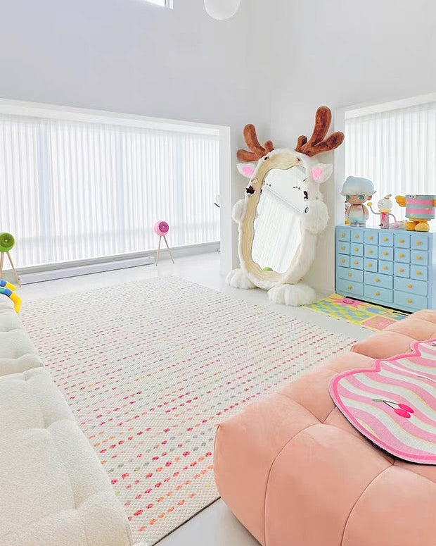 Children's playroom with toys and a rug featuring a deer design.