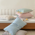 Striped cotton pillowcases with bow ties, ideal for college dorm bedding essentials.