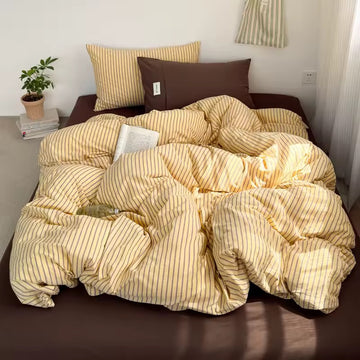 Striped yellow cotton bedding set for modern minimalist home decor.