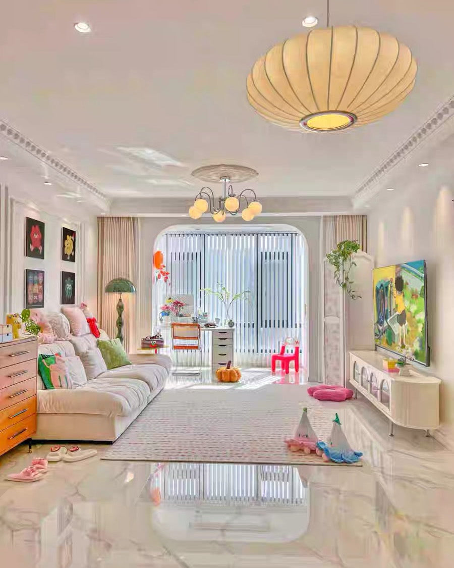 Modern living room with a large window, colorful decor, and a TV.