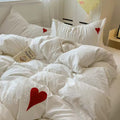 King size bed dressed in coquette bedding set with minimalist decor elements.