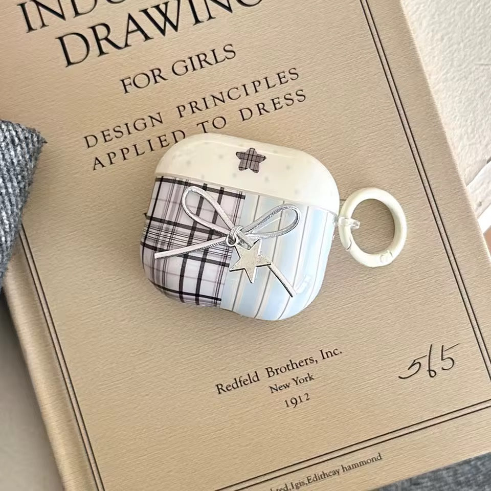 White air pod case with plaid design on a vintage book