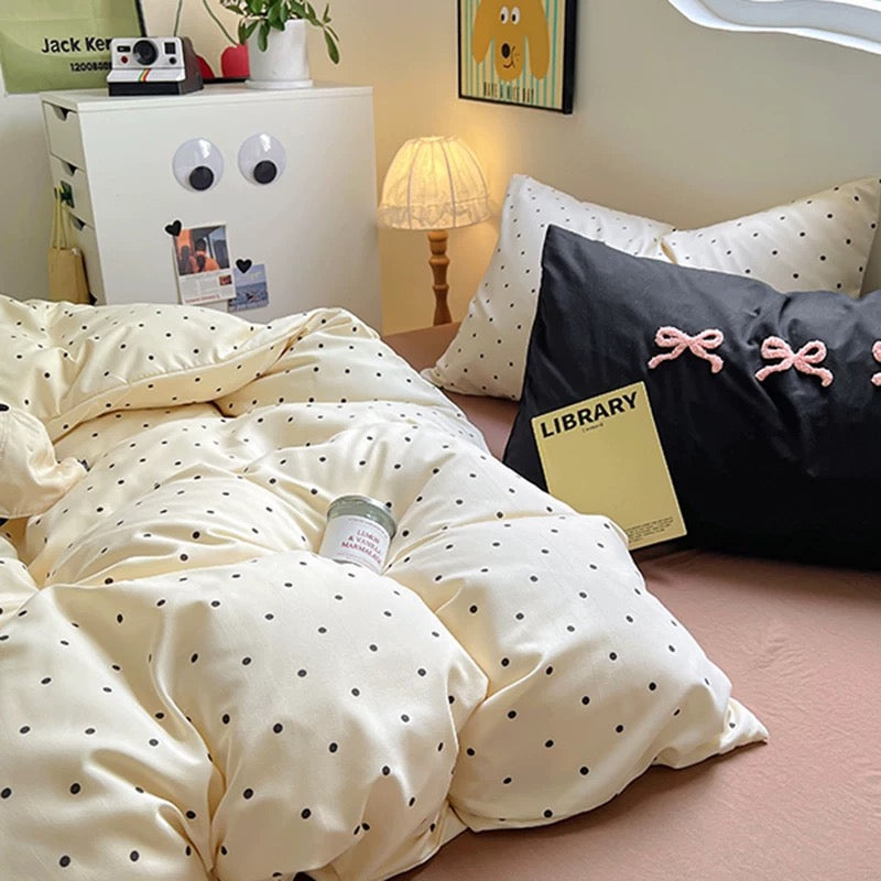 Duvet cover in soft brown and cream polka dots, surrounded by aesthetic accessories like headphones and soft lighting