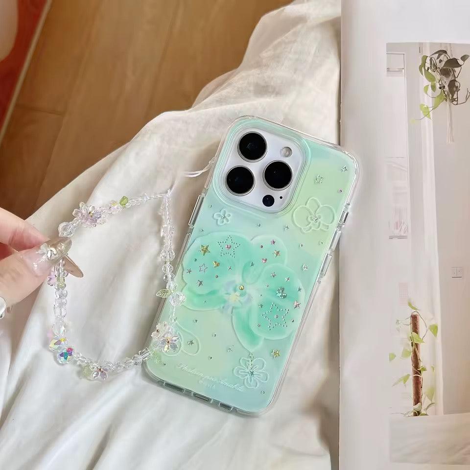 Phone case with decorative chain held by a hand on a light fabric background