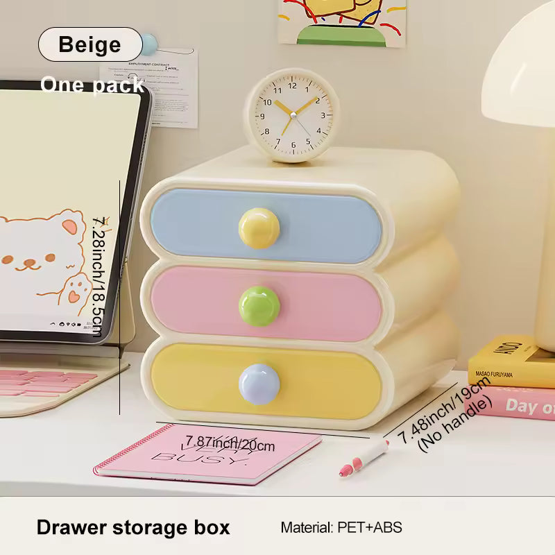 Pastel-colored drawer storage box with colorful knobs on a desk.