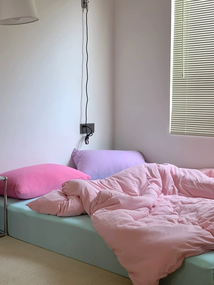 Pink pastel cotton bedding set styled in soft girl Danish dorm bedroom aesthetic