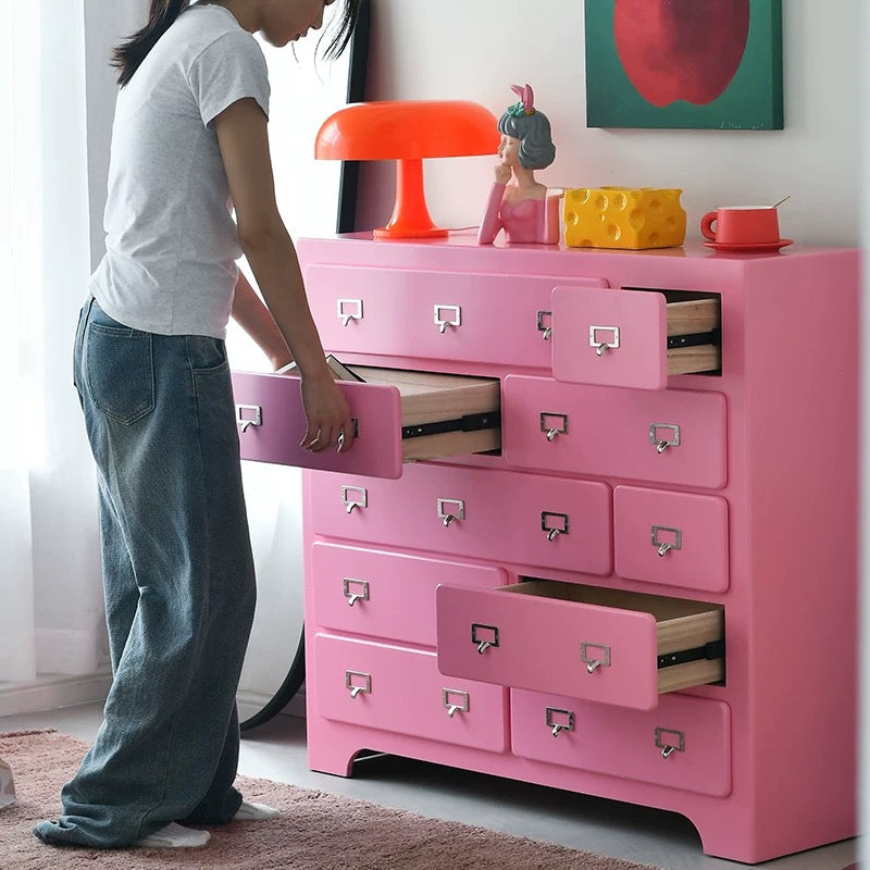 Dopamine pink drawer cabinet placed in entryway for cute organized storage solution