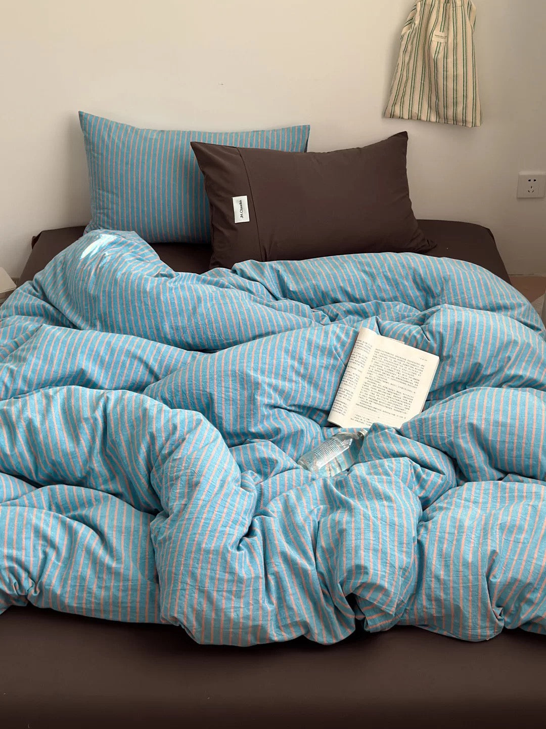Dorm bedding inspo – blue striped duvet cover with matching pillowcases, small room makeover.