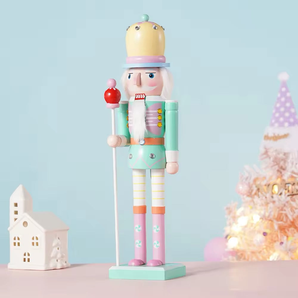 Pink macaron nutcracker figurine with candy-inspired design. Perfect Christmas gift or festive decor for home.