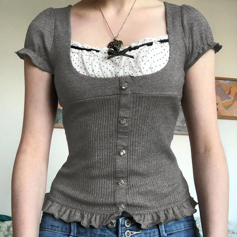 Y2K patchwork T-shirt with coquette ribbons and bow accents. Gray vintage crop top with puff sleeves and ruffle hem for retro aesthetic.