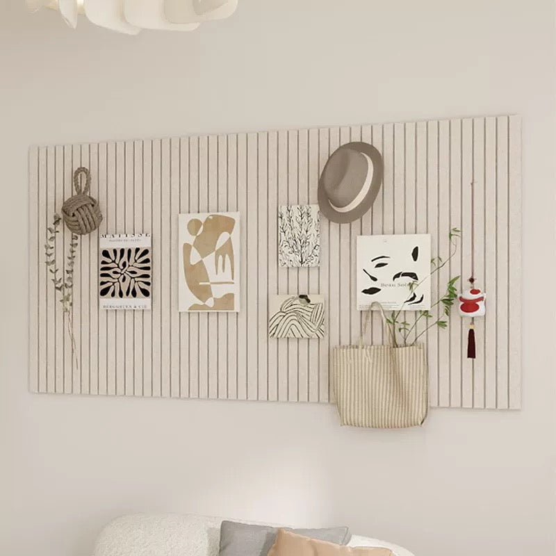 Wall with decorative items including a hat, plants, and framed art on a striped wall panel.