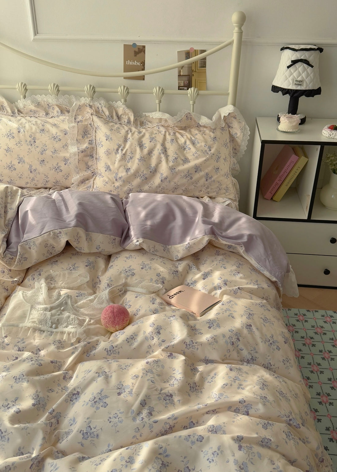 Bed with floral bedding and pillows in a bedroom setting.