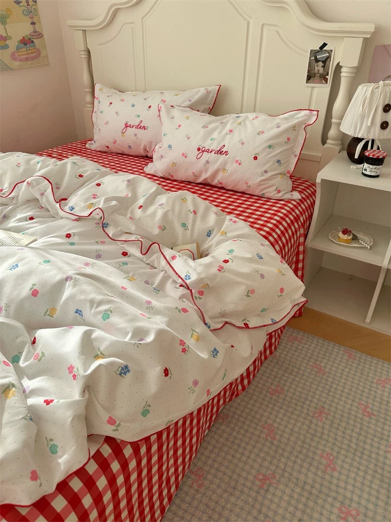 Children's bedroom with red and white checkered bedspread and matching pillows.