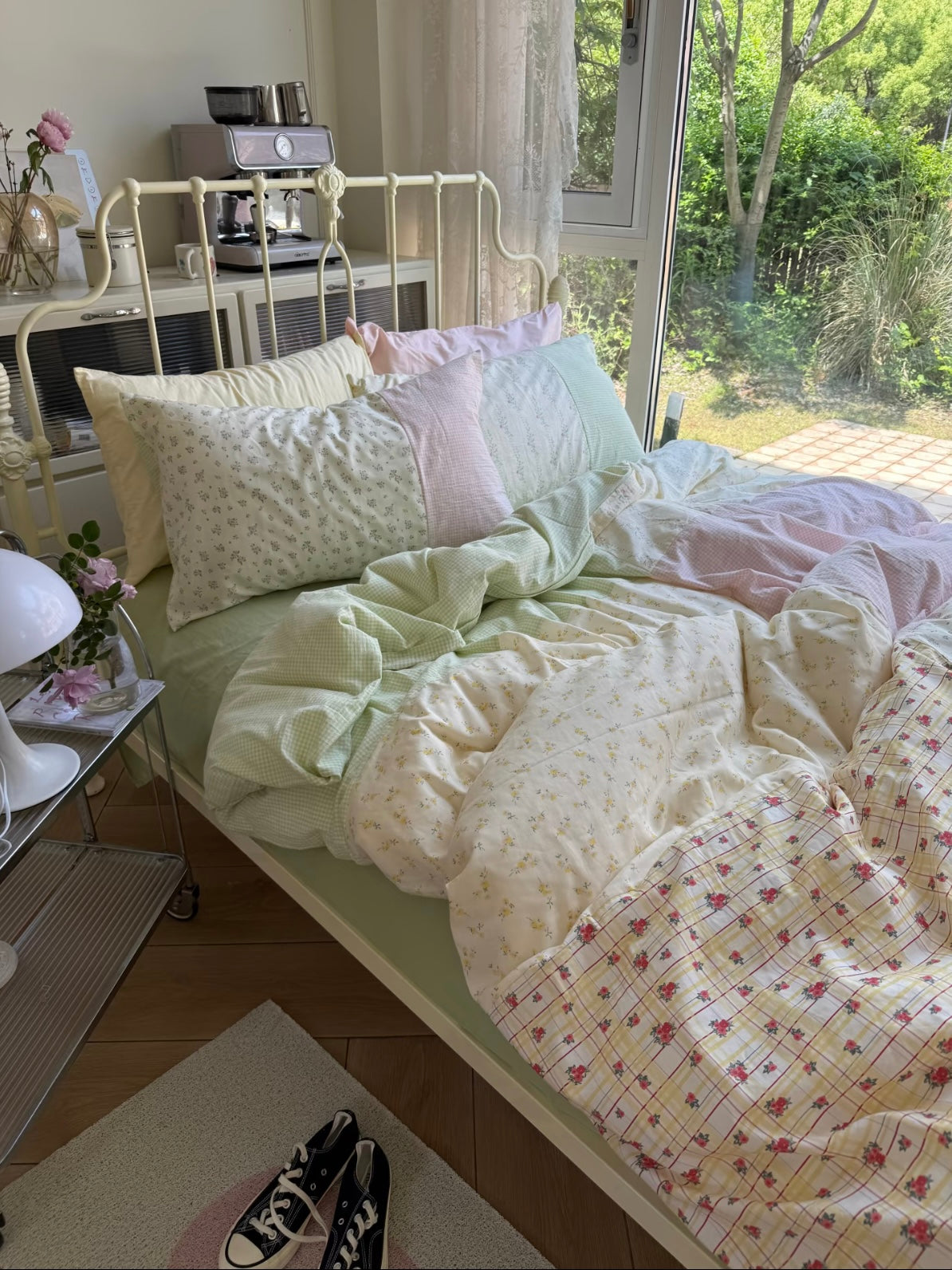 Floral patchwork bedding with green floral and pink gingham sections