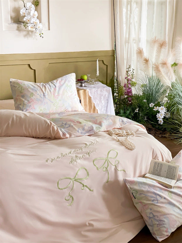 Delicate floral bedding set with embroidered designs in a bedroom setting.