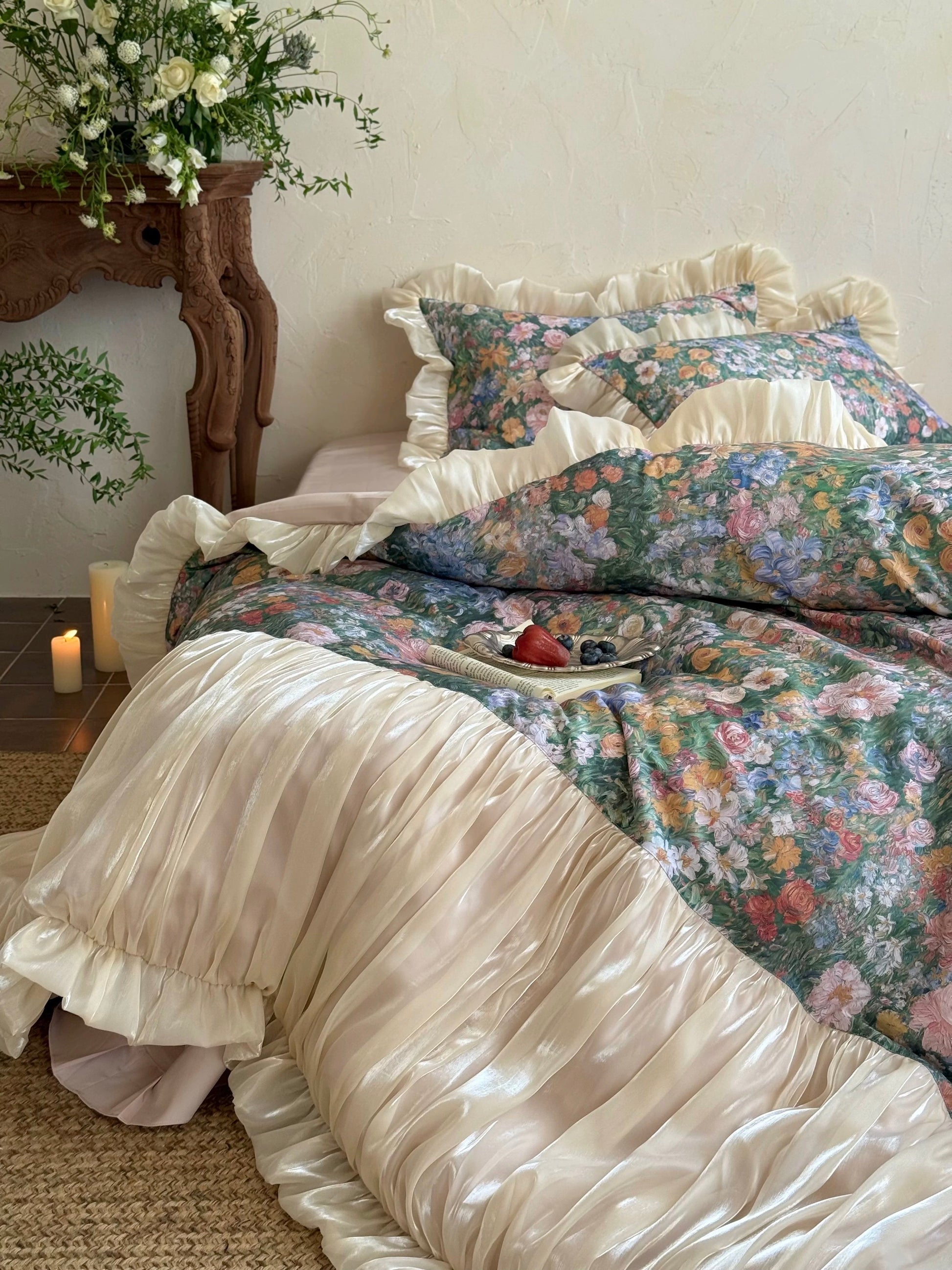 Floral bedding set with ruffled edges on a bed in a bedroom setting.