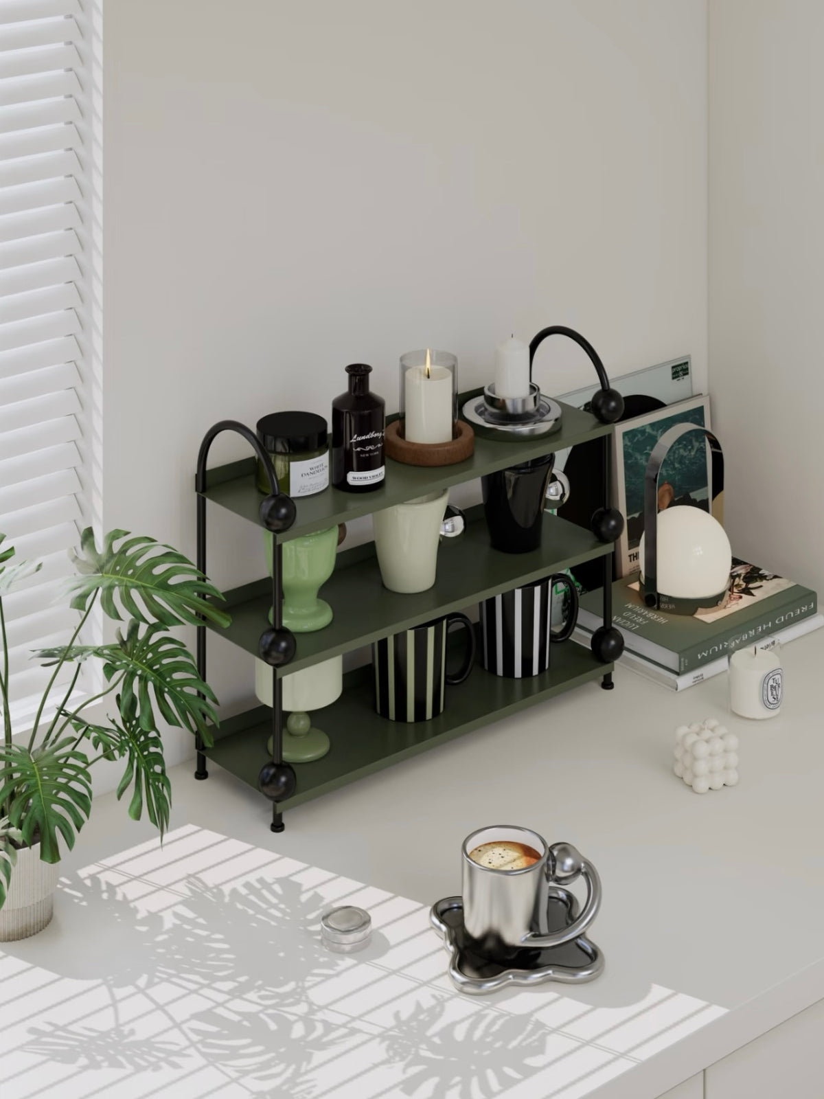 Green display shelf with black arches and ball details holds cups and bottles across three open tiers.