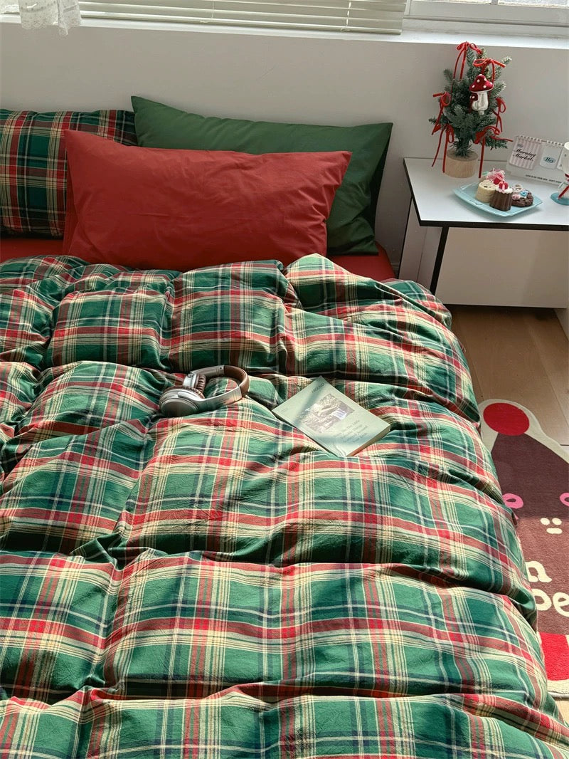 Bed with plaid bedding and pillows in a room setting