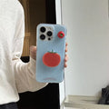 Tomato iPhone case shown on table with matching tomato decor.