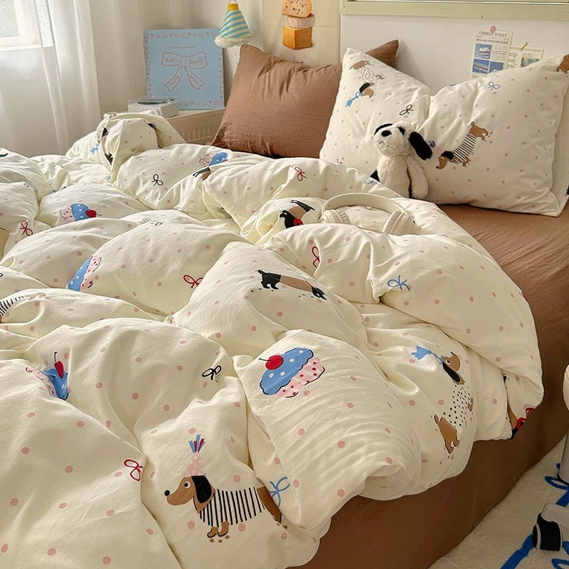 Bed with white comforter featuring cartoon dog designs in a bedroom setting.