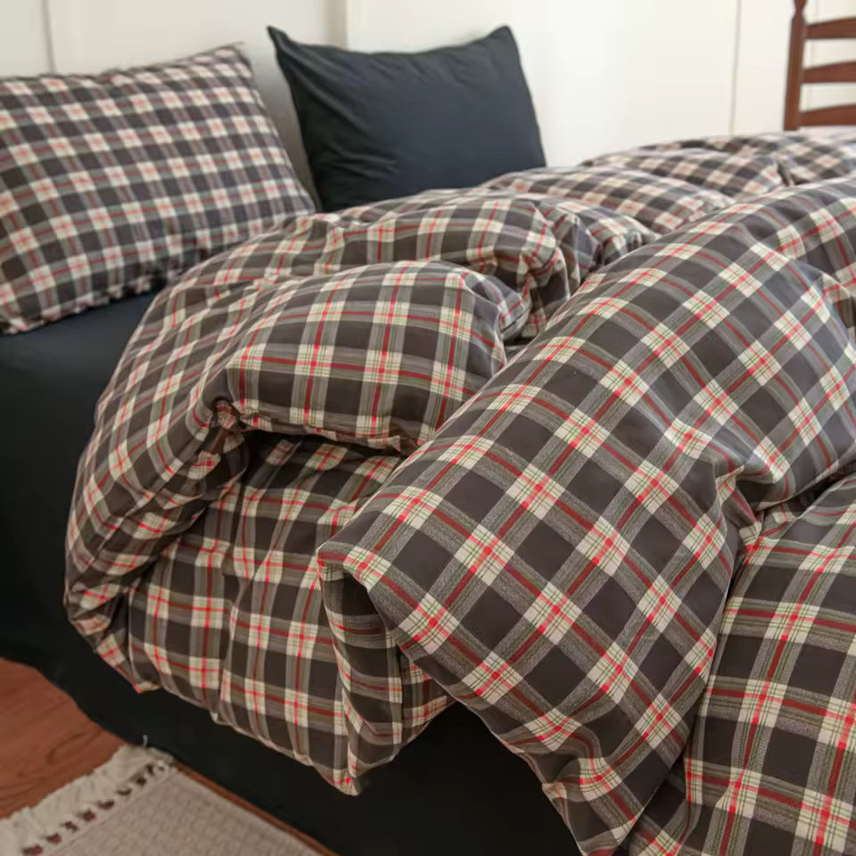 Plaid bedding set on a bed with pillows in a bedroom setting