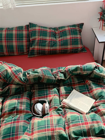 Bed with plaid bedding and pillows in a room setting