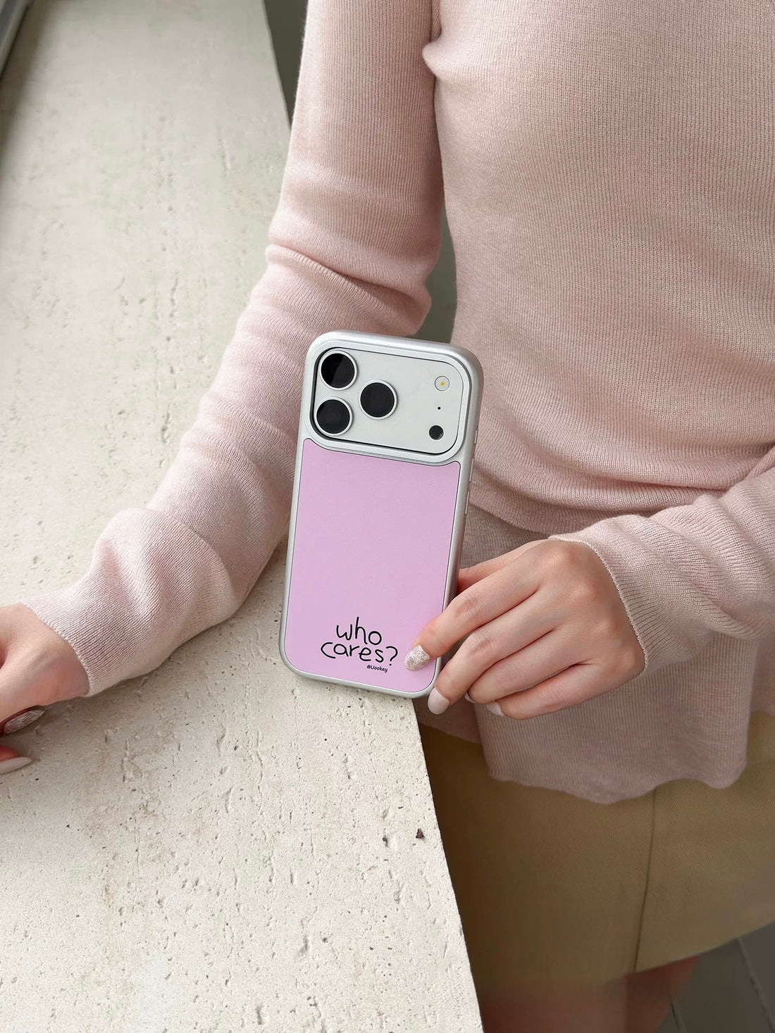 Soft Girl phone case in pale pink resting flat, with black lettering near the bottom of the back.