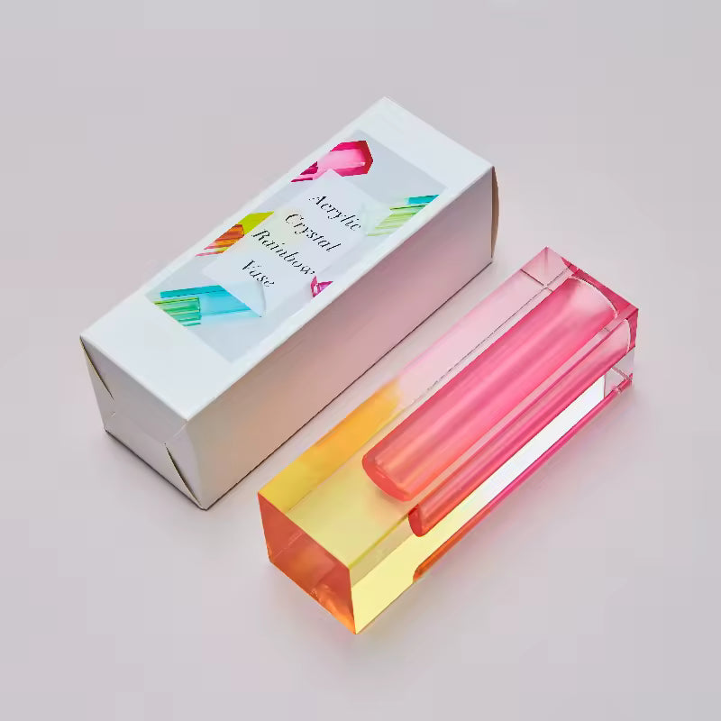 Acrylic crystal rainbow vase with packaging on a light gray background
