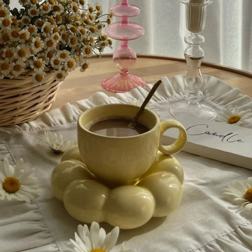Stylish yellow coffee mug with sunflower saucer. Unique design for afternoon tea, home, or office.