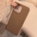 Brown phone case with a label on a white surface