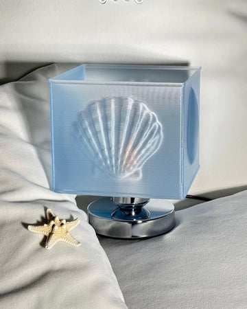 Decorative lamp with shell design on a soft fabric background