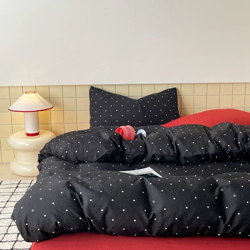 Minimalist black polka dot duvet cover styled for preppy college dorm bedroom aesthetic